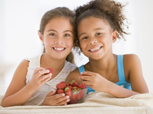 girls eating strawberries