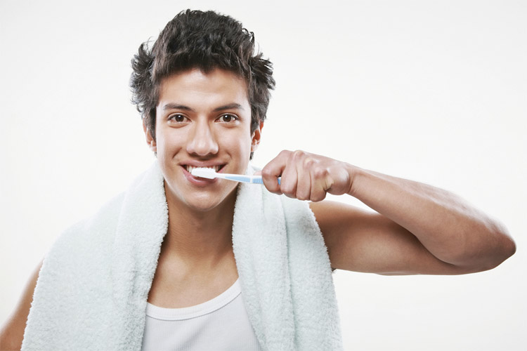 Guy brushing teeth daily